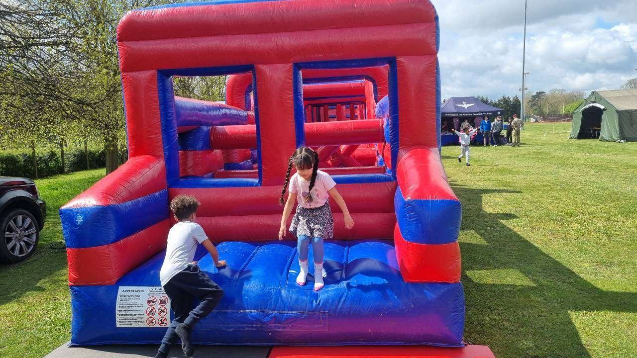 Group of children playing and having fun on the Mega Monster Fun Run inflatable obstacle course